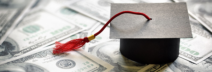 Graduation cap sitting on money