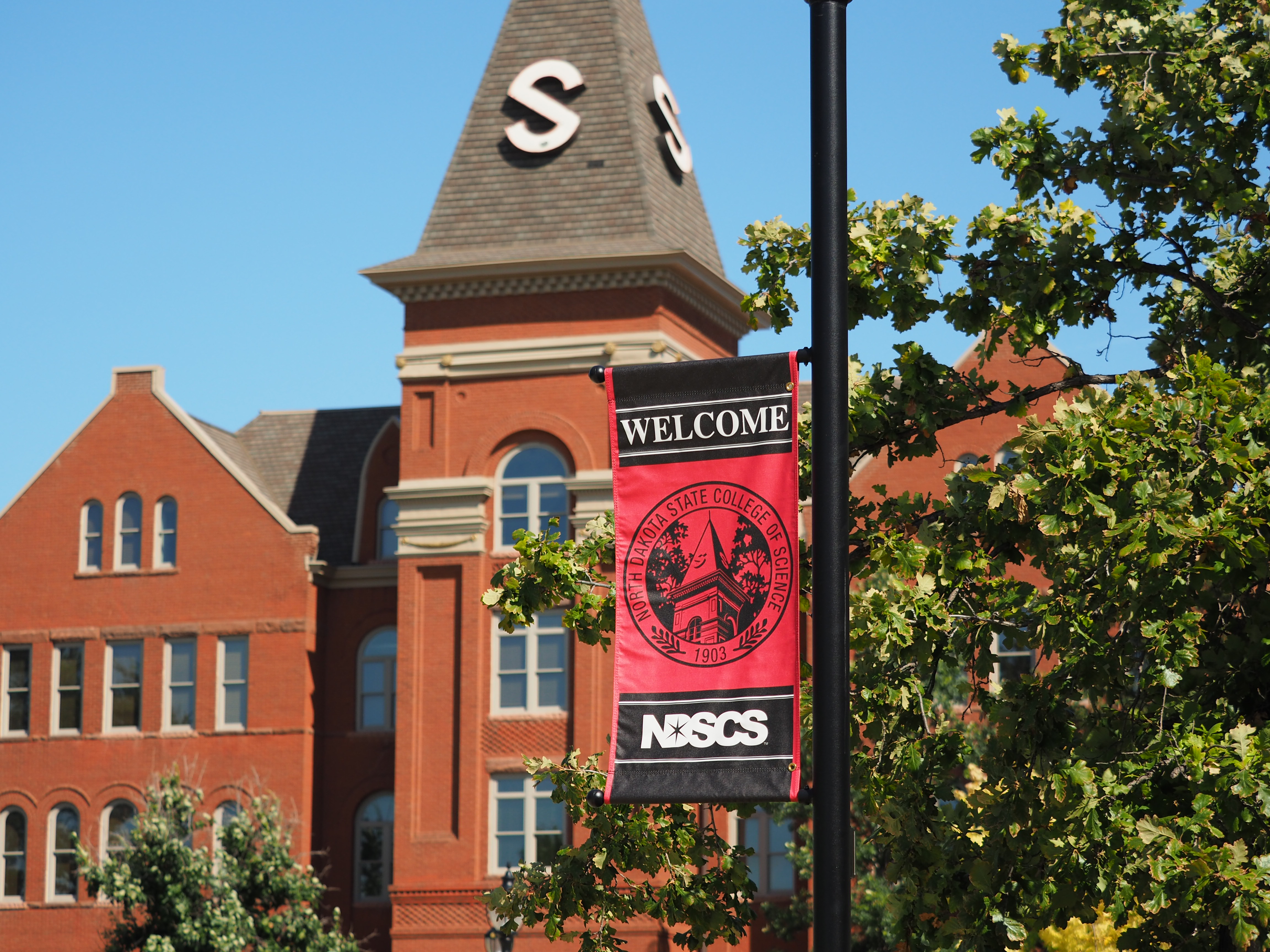 Old Main with Welcome sign