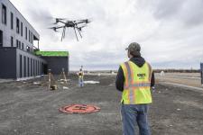 drone flying in area with land surveyors