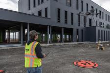 Drone flying in front of building under construction