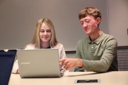 two students working together on a computer