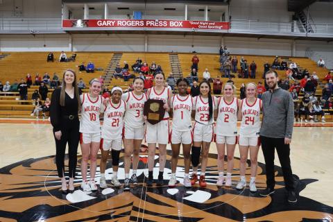 Women's Basketball team with district plaque
