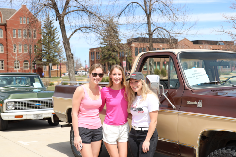 3 girls standing by a pickup in the Agawasie Day car show