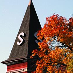 Old Main steeple with fall colored leaves